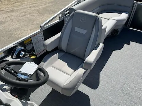 Slide: The Image of 2025 Godfrey EX2286SBCX boat interior with steering wheel and comfortable seating. - 6