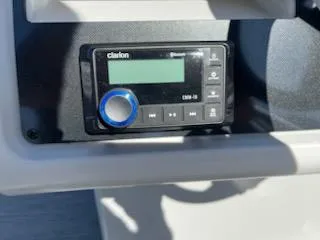 Slide: The Image of Clarion audio system in 2025 Godfrey EX2286SBCX boat dashboard. - 7