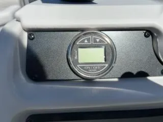 Slide: The Image of Control panel of 2025 Godfrey EX2286SBCX boat with digital display and buttons. - 8