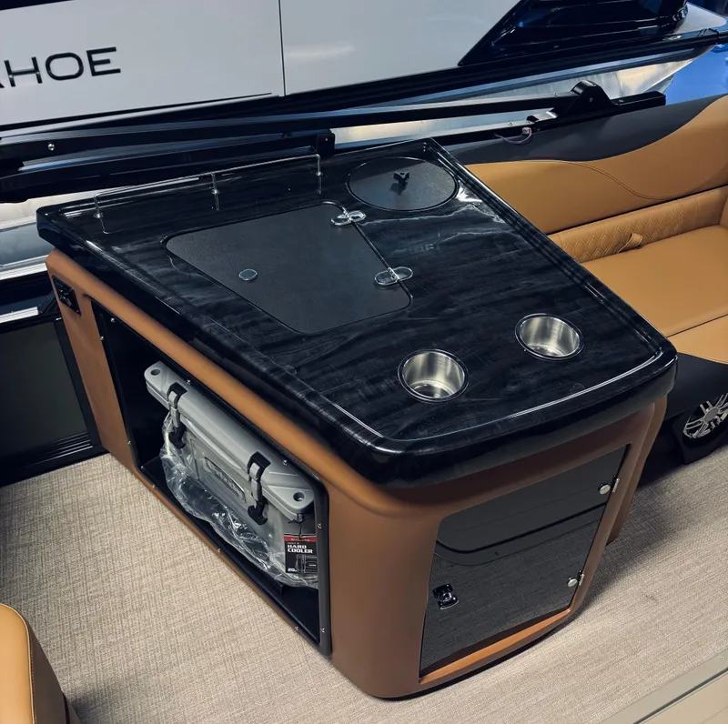 Slide: The Image of 2025 Tahoe Pontoon LTZ Elite Windshield interior with sleek black console and cup holders. - 10