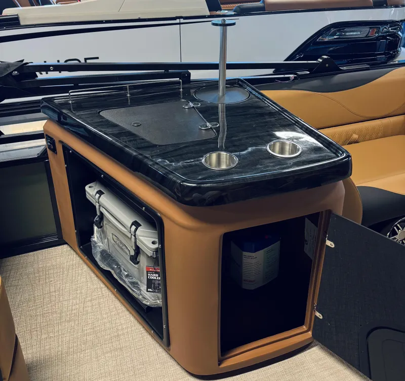 Slide: The Image of 2025 Tahoe Pontoon LTZ Elite Windshield interior with sleek bar setup and storage compartments. - 12