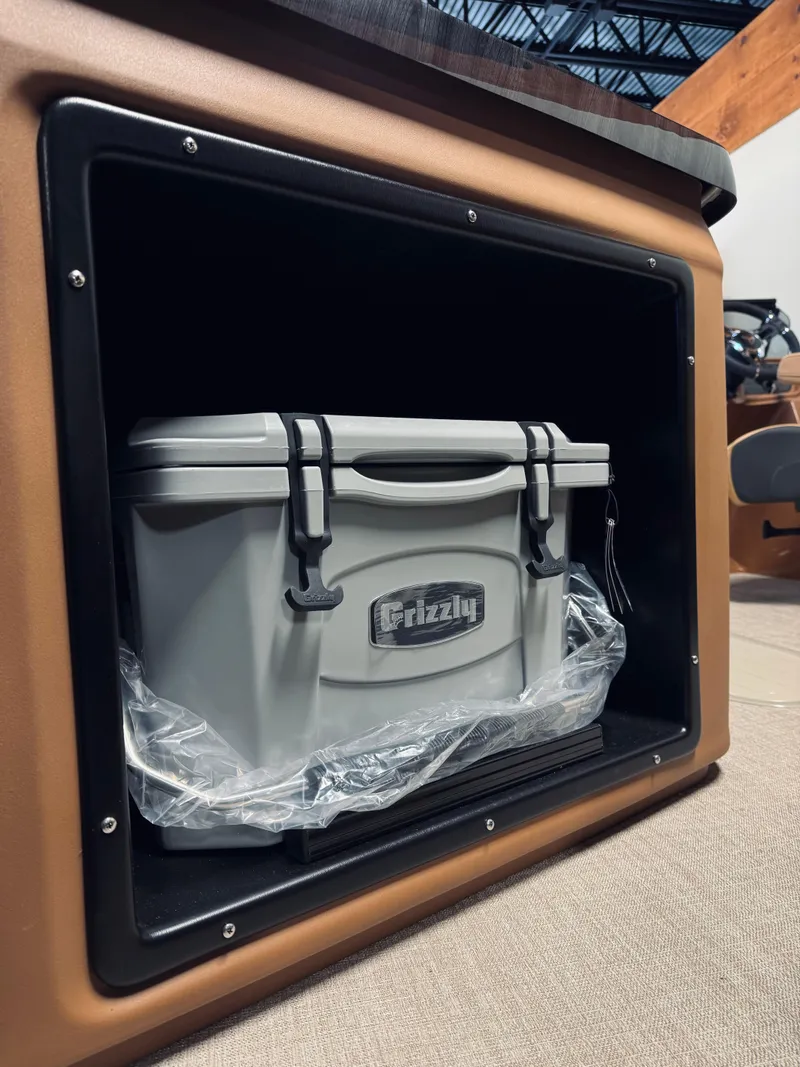 Slide: The Image of 2025 Tahoe Pontoon LTZ Elite Windshield storage with Grizzly cooler inside. - 13