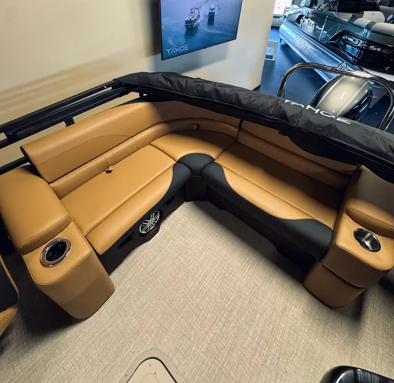 Slide: The Image of Luxurious interior of 2025 Tahoe Pontoon LTZ Elite Windshield with tan seating and cup holders. - 14