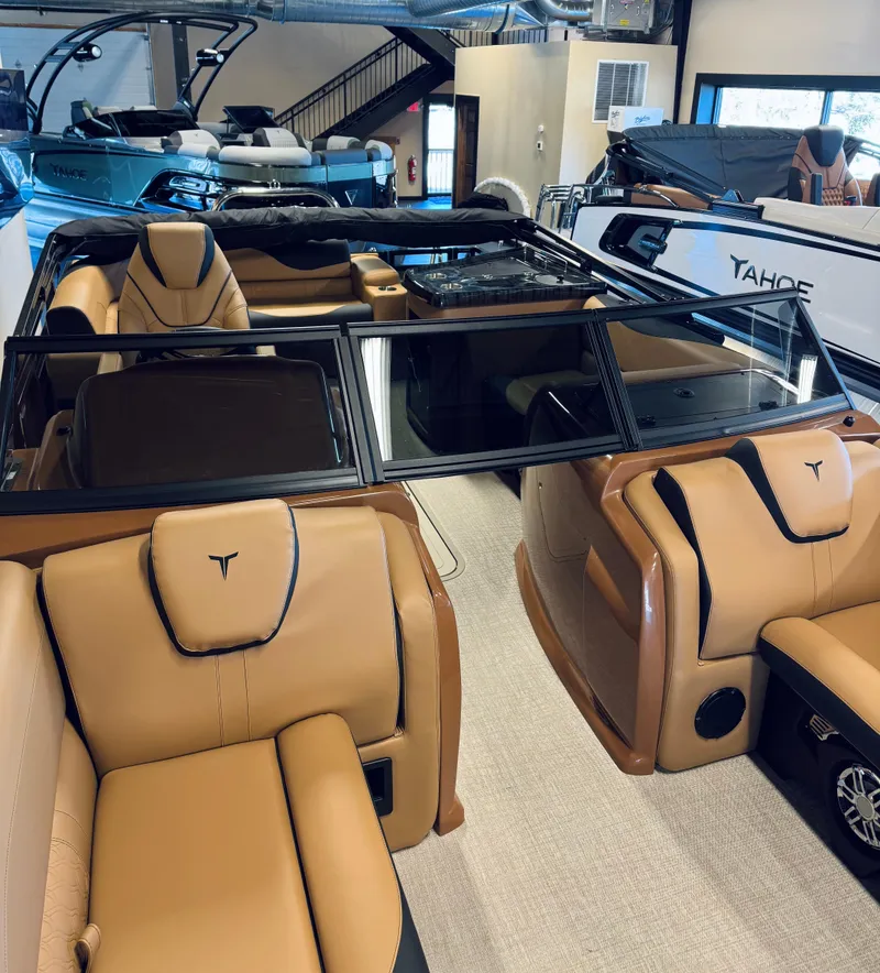 Slide: The Image of 2025 Tahoe Pontoon LTZ Elite Windshield with luxurious tan seating in showroom. - 7