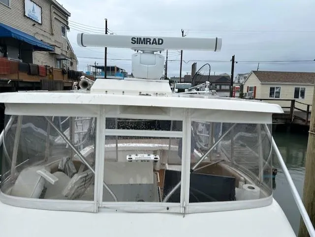 Slide: The Image of 1992 Luhrs Tournament 290 Open boat with Simrad radar, docked near waterfront buildings. - 10