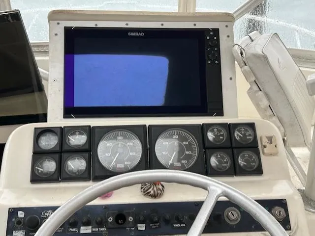 Slide: The Image of 1992 Luhrs Tournament 290 Open helm with gauges and Simrad display. - 4