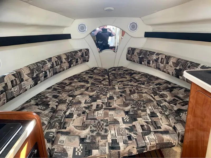 Slide: The Image of Interior of 2003 Rinker 270 boat with patterned seating and wood accents. - 3