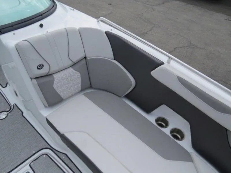 Slide: The Image of 2023 Hurricane SunDeck 2400 OB boat interior with gray and white seating and cup holders. - 10