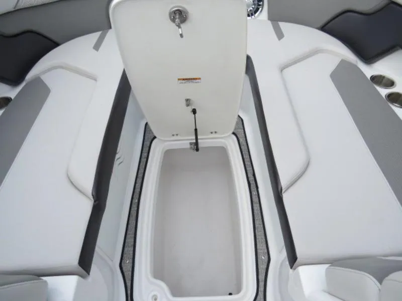 Slide: The Image of 2023 Hurricane SunDeck 2400 OB boat interior with open storage compartment. - 12
