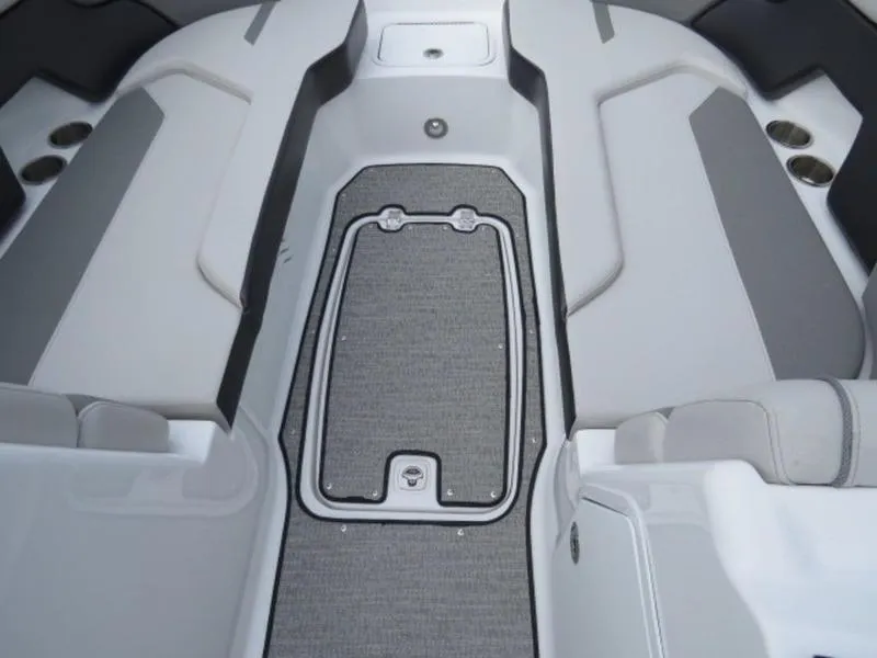 Slide: The Image of 2023 Hurricane SunDeck 2400 OB interior with gray seating and storage compartment. - 16