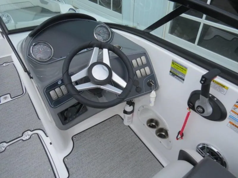 Slide: The Image of 2023 Hurricane SunDeck 2400 OB boat dashboard with steering wheel and control panel. - 18