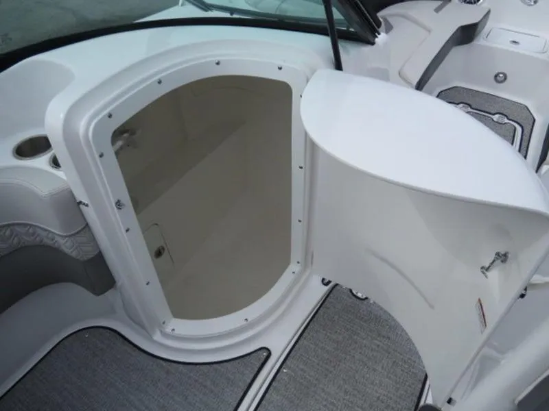 Slide: The Image of 2023 Hurricane SunDeck 2400 OB boat interior with open storage compartment. - 2