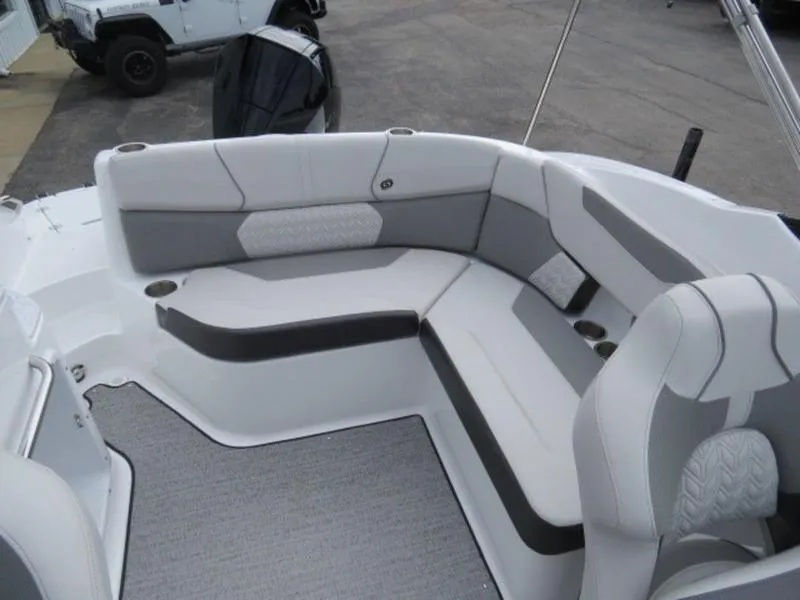 Slide: The Image of 2023 Hurricane SunDeck 2400 OB boat interior with gray seating and carpeted floor. - 22