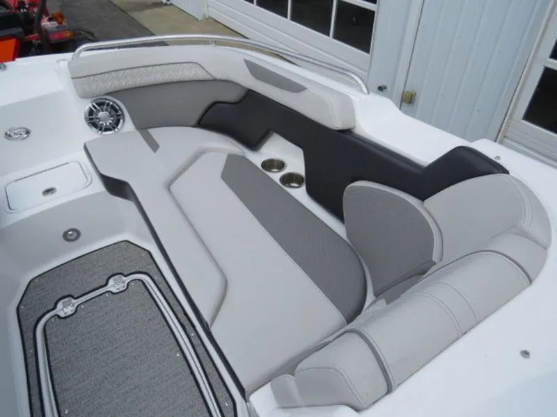 Slide: The Image of 2023 Hurricane SunDeck 2400 OB boat interior with gray seating and speaker. - 28