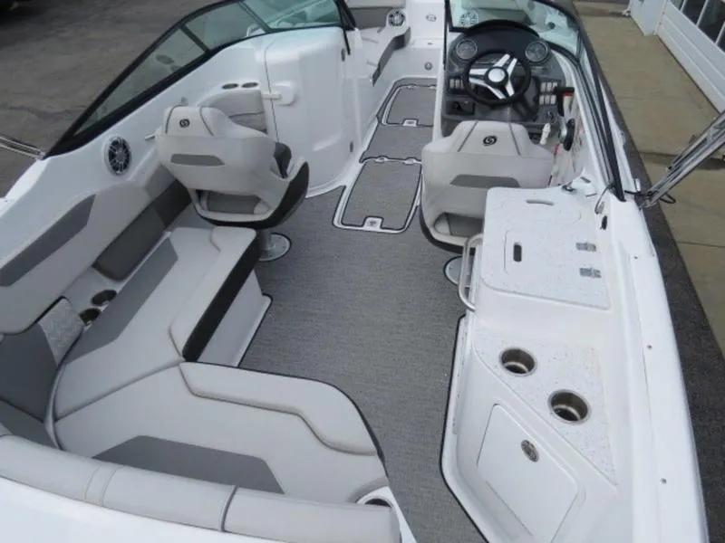 Slide: The Image of 2023 Hurricane SunDeck 2400 OB interior with seating, steering console, and cup holders. - 4