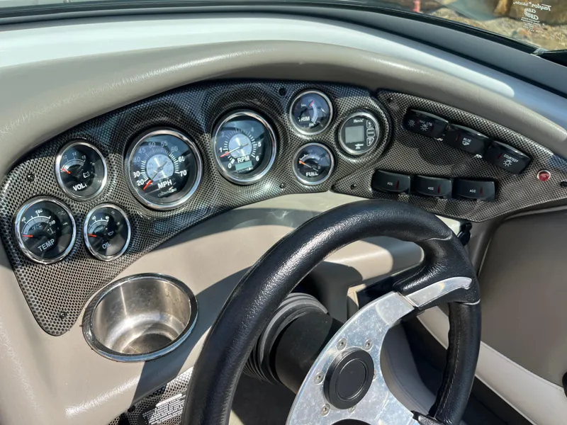 Slide: The Image of Dashboard of 2008 Crownline 23SS boat with gauges and steering wheel. - 10