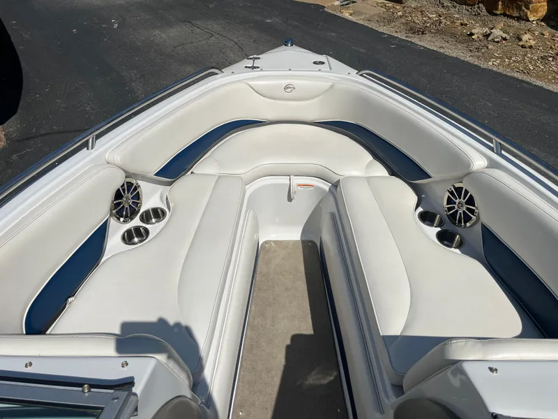 Slide: The Image of 2008 Crownline 23SS boat interior with white seating and cup holders. - 11