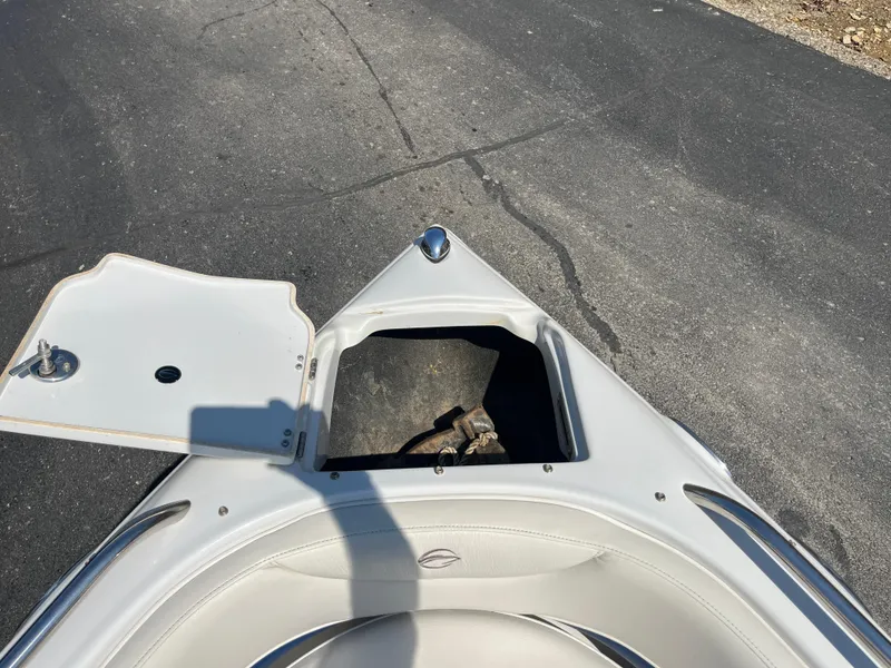 Slide: The Image of Bow of 2008 Crownline 23SS boat with open storage compartment. - 12
