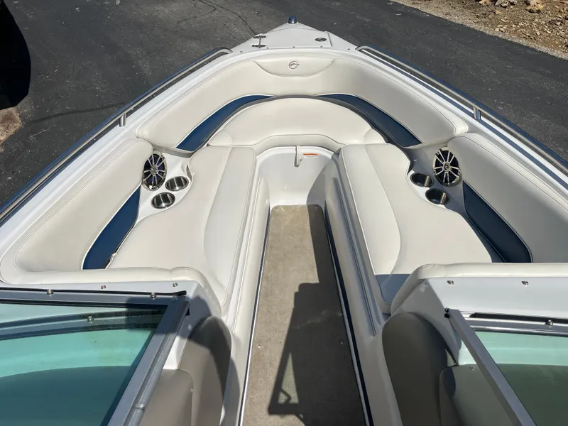 Slide: The Image of 2008 Crownline 23SS boat interior with white seating and cup holders. - 13