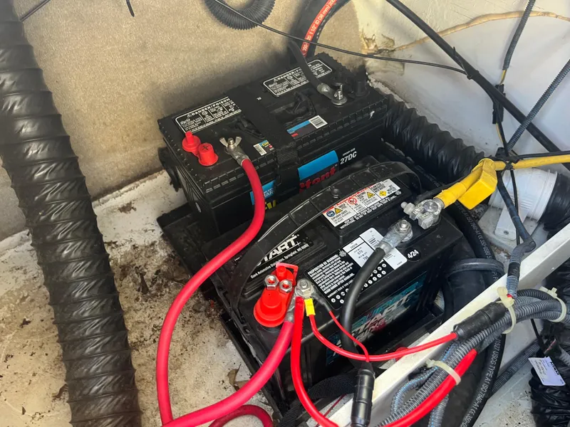 Slide: The Image of Battery compartment of a 2008 Crownline 23SS boat with connected cables. - 16
