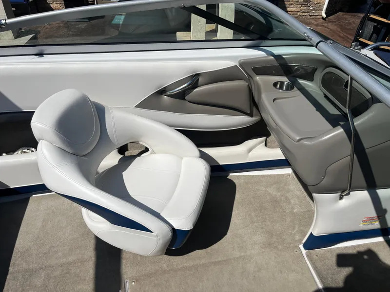 Slide: The Image of 2008 Crownline 23SS boat interior with white seating and gray accents. - 23