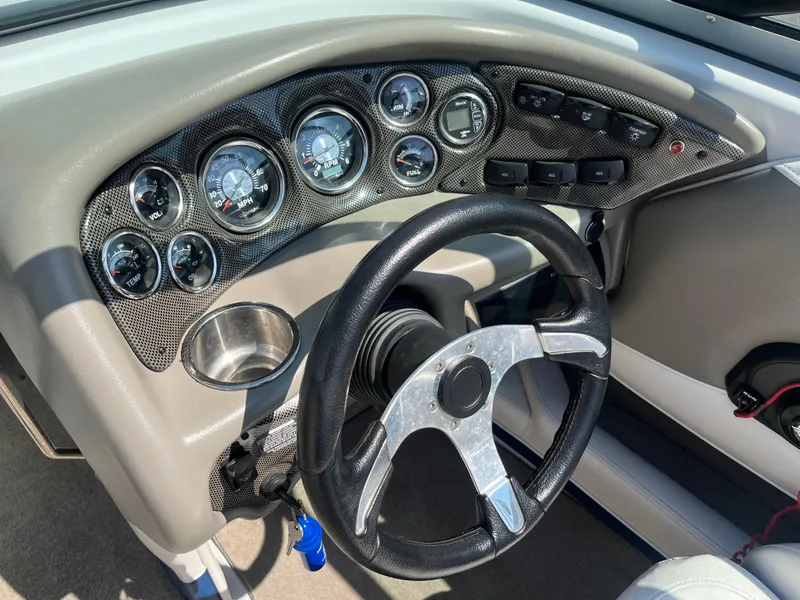 Slide: The Image of Dashboard of a 2008 Crownline 23SS boat with gauges and steering wheel. - 24