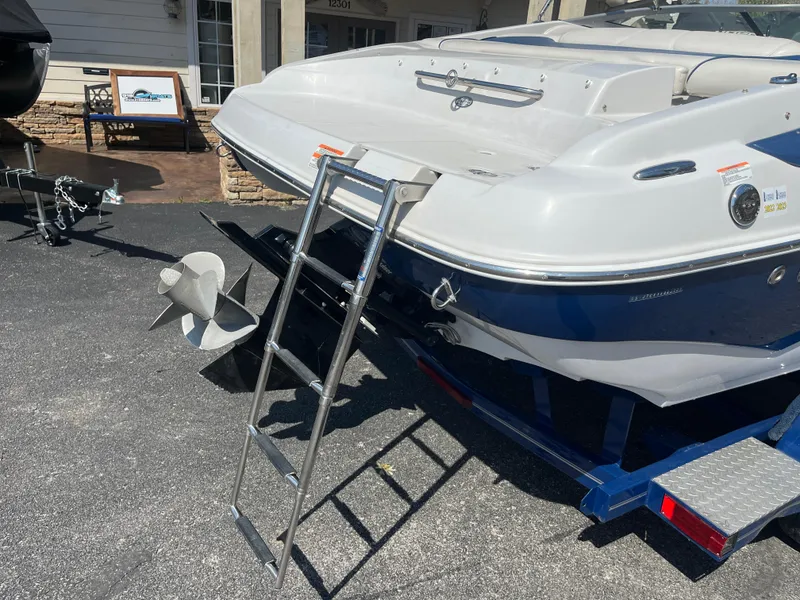 Slide: The Image of 2008 Crownline 23SS boat with ladder on trailer, displayed outdoors. - 27