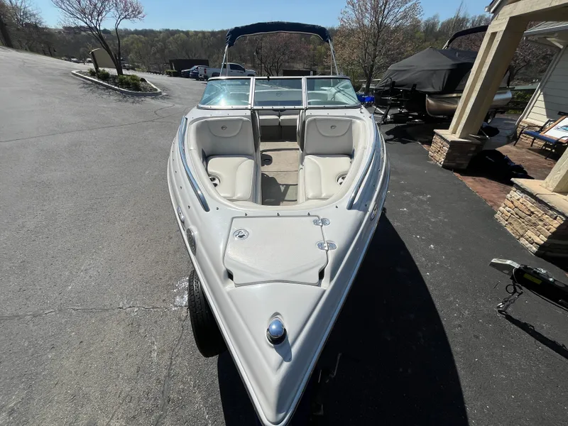 Slide: The Image of 2008 Crownline 23SS boat on trailer, parked outdoors, showcasing sleek design and spacious seating. - 3