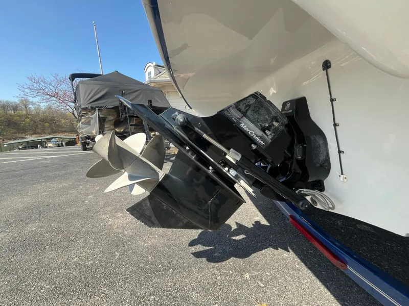Slide: The Image of 2008 Crownline 23SS boat propeller and stern drive on a trailer, parked outdoors. - 30