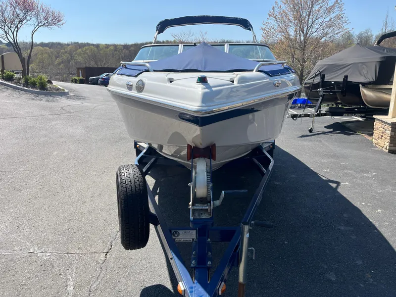 Slide: The Image of 2008 Crownline 23SS boat on trailer, parked outdoors on a sunny day. - 31