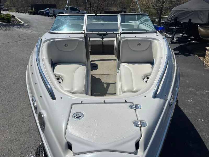 Slide: The Image of 2008 Crownline 23SS boat with open bow seating, parked outdoors. - 4
