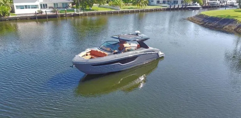 Slide: The Image of 2023 Cruisers Yachts 38 GLS on a serene waterway, showcasing sleek design and luxury features. - 2