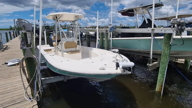 The Image of 2016 Tidewater 2200 Carolina Bay boat docked at marina under blue sky. - 0