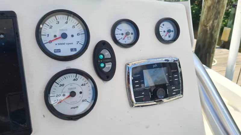 Slide: The Image of Dashboard of 2016 Tidewater 2200 Carolina Bay boat with gauges and controls. - 12
