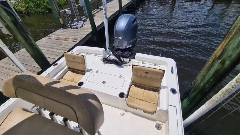 Slide: The Image of 2016 Tidewater 2200 Carolina Bay boat with Yamaha engine, docked by wooden pier. - 13