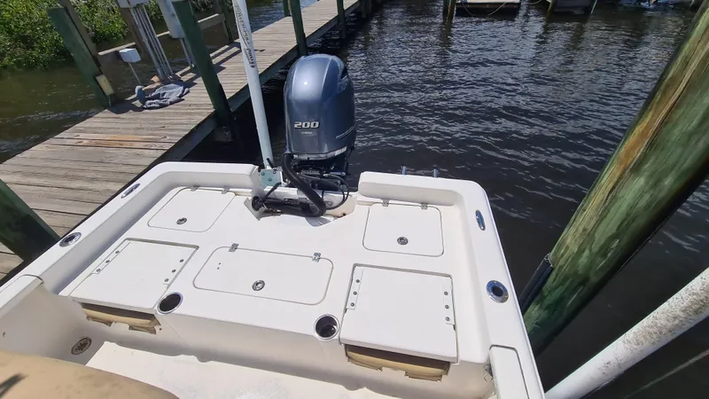 Slide: The Image of 2016 Tidewater 2200 Carolina Bay boat with outboard motor at dock. - 16