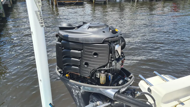 Slide: The Image of Outboard motor of a 2016 Tidewater 2200 Carolina Bay boat on water. - 18