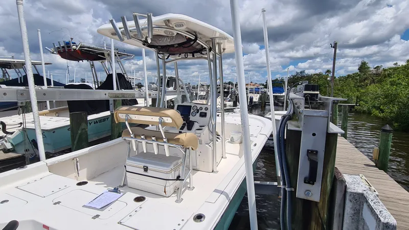 Slide: The Image of 2016 Tidewater 2200 Carolina Bay boat docked under cloudy skies. - 3