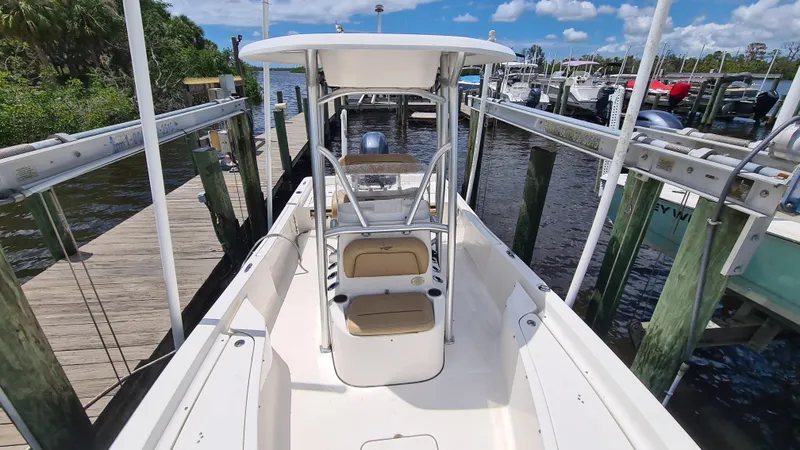 Slide: The Image of 2016 Tidewater 2200 Carolina Bay boat docked at marina under clear blue sky. - 9
