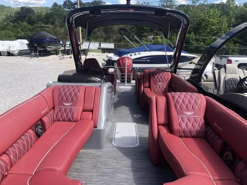 Slide: The Image of 2021 Bennington 23 RCWA pontoon boat with luxurious red seating and sleek design. - 4