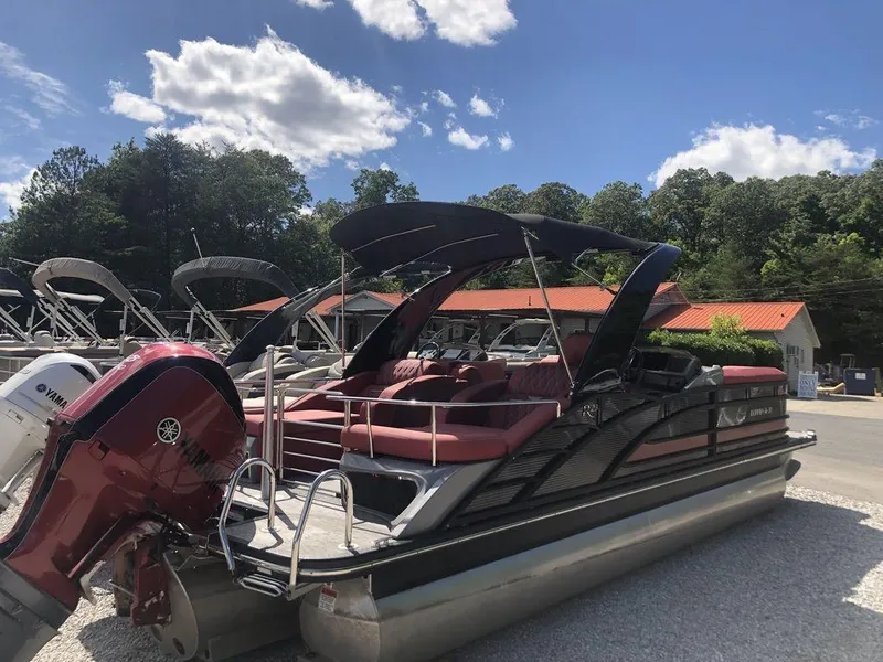 Slide: The Image of 2021 Bennington 23 RCWA pontoon boat with Yamaha engine, parked outdoors under blue sky. - 9