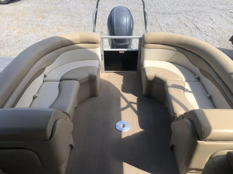 Slide: The Image of 2017 Bennington 24SSRX pontoon boat interior with beige seating and outboard motor. - 4