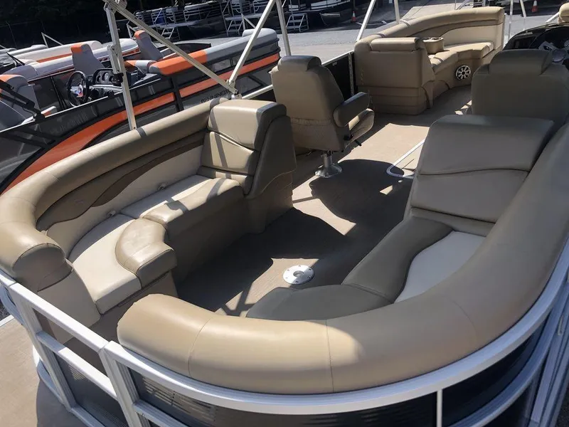 Slide: The Image of 2017 Bennington 24SSRX pontoon boat with spacious beige seating and modern design. - 6