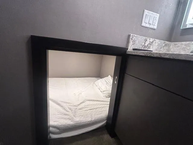 Slide: The Image of Compact sleeping area in 2020 Adonia houseboat, featuring cozy bedding and modern design. - 13