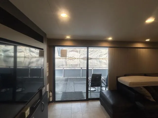 Slide: The Image of Interior of 2020 Adonia houseboat with modern furnishings and large sliding glass doors. - 20