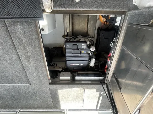 Slide: The Image of Engine compartment of a 2020 Adonia Houseboat, showcasing mechanical components and interior design. - 21