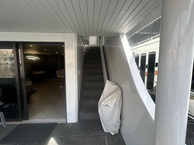 Slide: The Image of Modern Adonia 2020 houseboat interior with stairs and sliding glass door. - 25