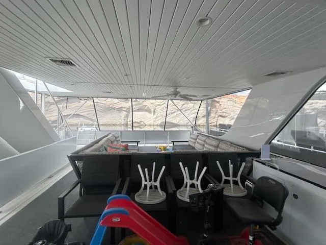 Slide: The Image of Spacious 2020 Adonia houseboat interior with seating, tables, and a children's slide. - 27