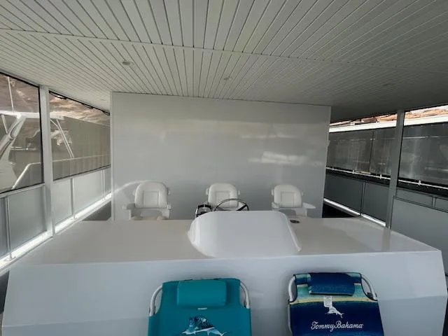 Slide: The Image of 2020 Adonia houseboat interior with seating and helm, featuring modern design elements. - 28