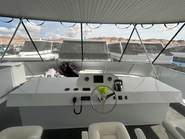 Slide: The Image of Pilothouse of 2020 Adonia Houseboat with steering wheel and control panel. - 29